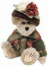 Boyds Aunt Fanny Fremont Teddy Bear - (introduced Fall 1999 and has been retired)  During that long Hibearnation last winter, Aunt Fanny sat in the den, knitting and crocheting her lovely Ensemble. (You thought all those Bears did was Sleep?!) Now that the chilly days of Autumn are here once again, Fanny gets to show off her creation...her nephew Logan added those lovely Silk Mums to her hat just as they set out for their visit to the City. What a nice touch!  8 inches and poseable