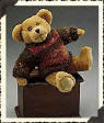 Boyds Logan Fremont Teddy Bear - (introduced Fall 1999 and has been retired)  Logan seems to be a true Master of Disguises! Sometimes he's a golden plush bear with eyebrows (a dead ringer for our retired Leon)... Sometimes he's a brown chenille antique-style bruin who looks like Morris...and upon occasion he has impersonated Bromley, in gold chenille. Well, now the truth can come out...Logan is really Triplets! The brothers Fremont fought so long and hard over who would get to wear that gorjuss knit sweater of Spruce and Spice - that Aunt Fanny (their guardian) made them Take Turns. Play fair, boys!  8 inches and poseable