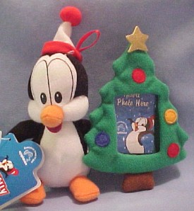 The adorable Penguin Chilly Willy is all dressed up for Christmas and holding a Christmas Tree as this Ornament.