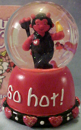 Gund Valentine's Day Musical Water Globe Little Devil
- Plays "Love Me Tender"
- Comes boxed in a decorated gift box (see background of picture)
- Small red hearts and glitter in globe. On the base it reads "So Hot!" Has hearts and beads around bottom of base. He is holding a flame in one hand and pitchfork in the other.