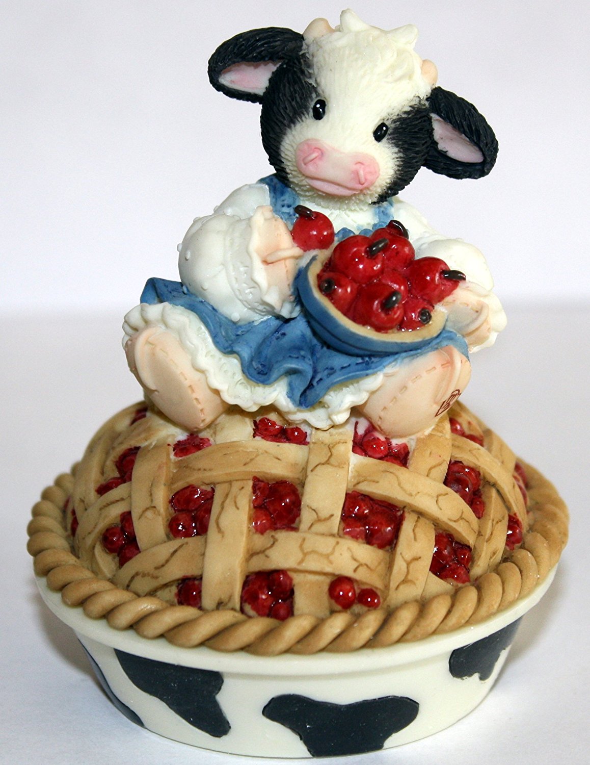 Mary's Moo Moos Cow Pies figurines are adorable cows sitting on top of cerry pies, pumpkin pies, and chocolate pies.