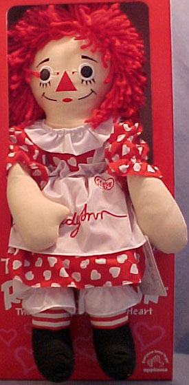 Talking Plush Raggedy Ann Rag Doll in Red with White Heart Polka Dot Dress
- Raggedy Ann is dressed in a red dress with white heart polka dots. Over the dress is a white collar at her neck and a white apron with Raggedy Ann embroidered in red on the front. Peeking from under her dress are white pantaloons. Under the pantaloons are red and white striped socks.
- safe for ages over 3 
- made by Applause