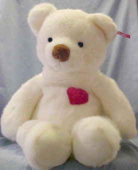 These adorable white Teddy Bears have a Red Heart. They are all white and furry! On their cheeks they have a slight blush. Made by Russ Berrie in 1998.